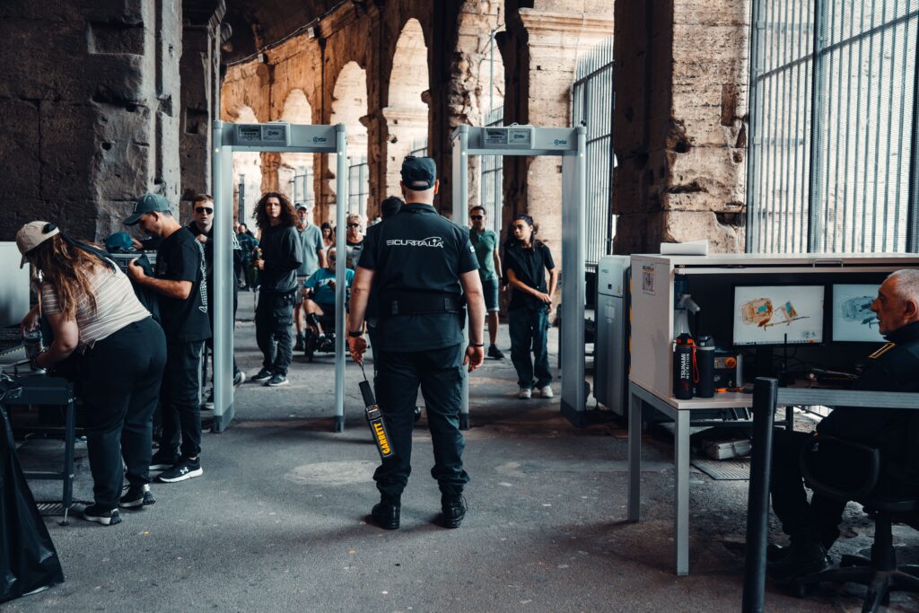 Security checkpoint with guards at a bustling historical site entrance.